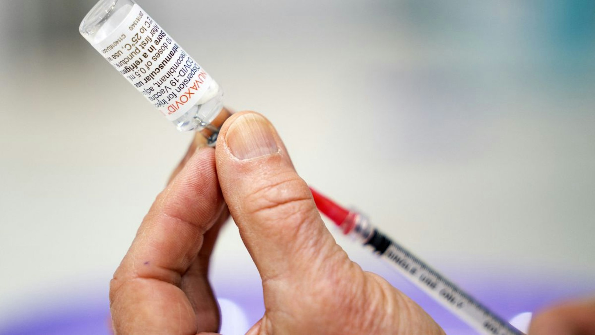 A healthcare worker prepares a dose of Nuvaxovid vaccine from Novavax in Utrecht on March 15, 2022.