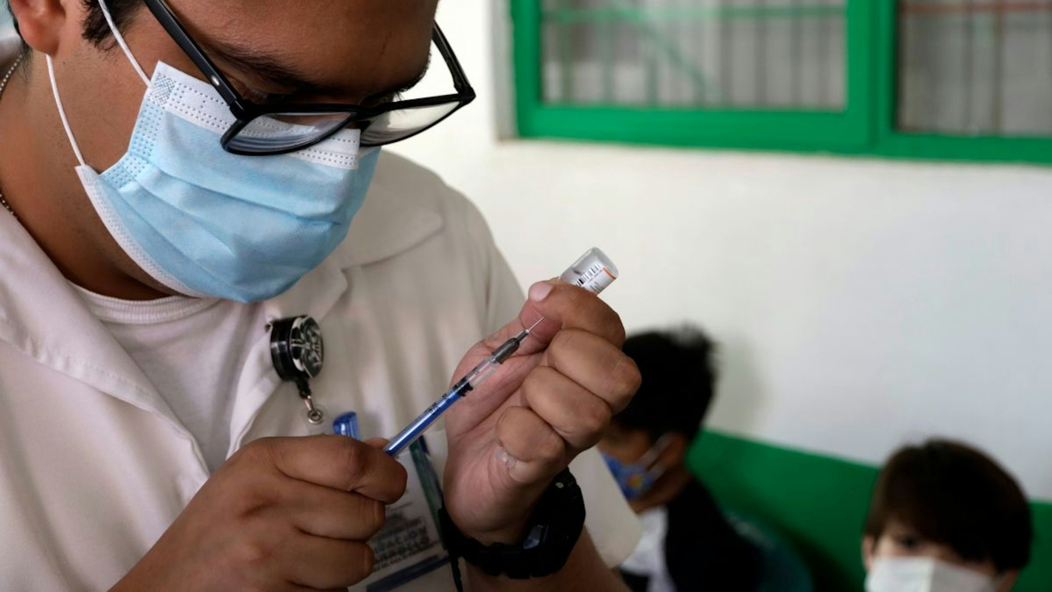 A health worker prepares a Pfizer's Covid19 dose during a mass vaccination campaign for children under 9 years of age to prevent infections by Covid-19 disease inside at the Portales Health Center.