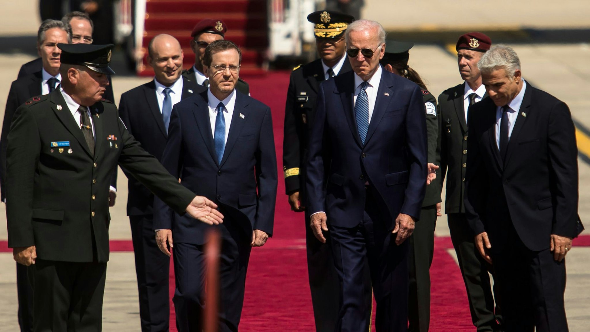 LOD, ISRAEL - JULY 13: U.S. President Joe Biden is welcomed by Israeli Prime Minister Yair Lapid and Israeli President Isaac Herzog during an arrival ceremony at Ben Gurion Airport on July 13, 2022 in Lod, Israel.