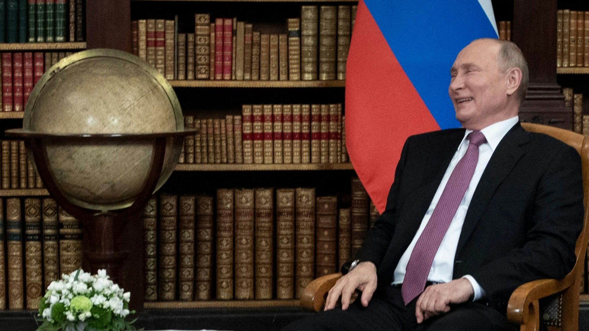 Russian President Vladimir Putin laughs as he waits for the US-Russia summit at the Villa La Grange, in Geneva on June 16, 2021