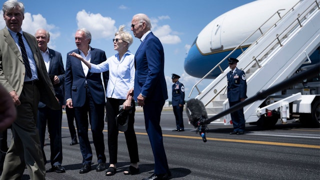 US President Joe Biden speaks with US Senator Elizabeth Warren after arriving at Rhode Island T.F. Green International Airport July 20, 2022, in Warwick, Rhode Island.