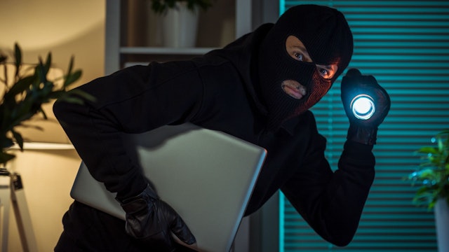 Thief stealing laptop