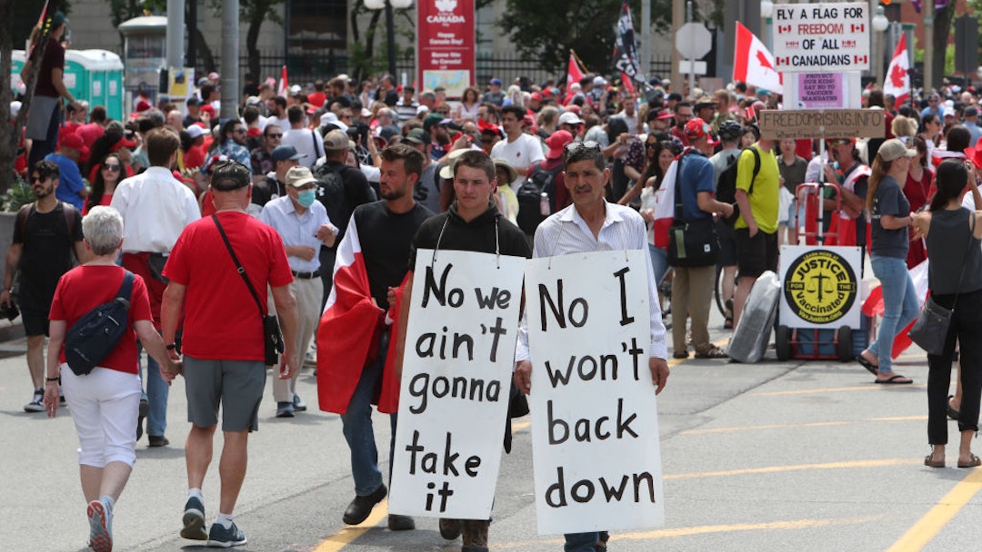 Demonstrators and revelers along Wellington Street near Parliament Hill on Canada Day in Ottawa, Ontario, Canada, on Friday, July 1, 2022. For the first time in 50 years, the main celebrations will not be on Parliament Hill, as Centre Block is under construction, The Canadian Press reports.