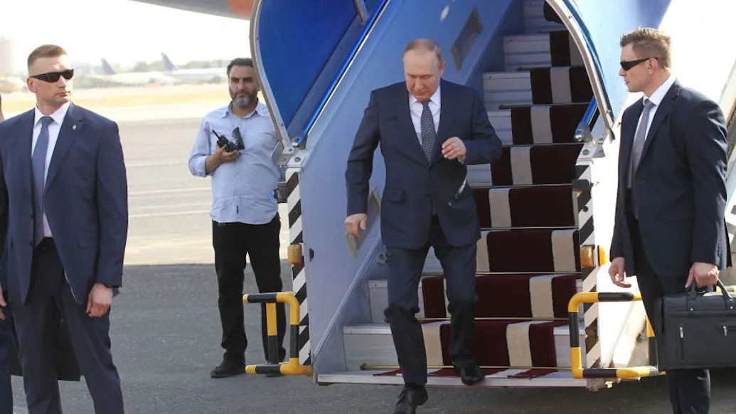 WATCH: Putin Hobbles Down Red Carpet With Arm Hanging Limp On Iran Trip