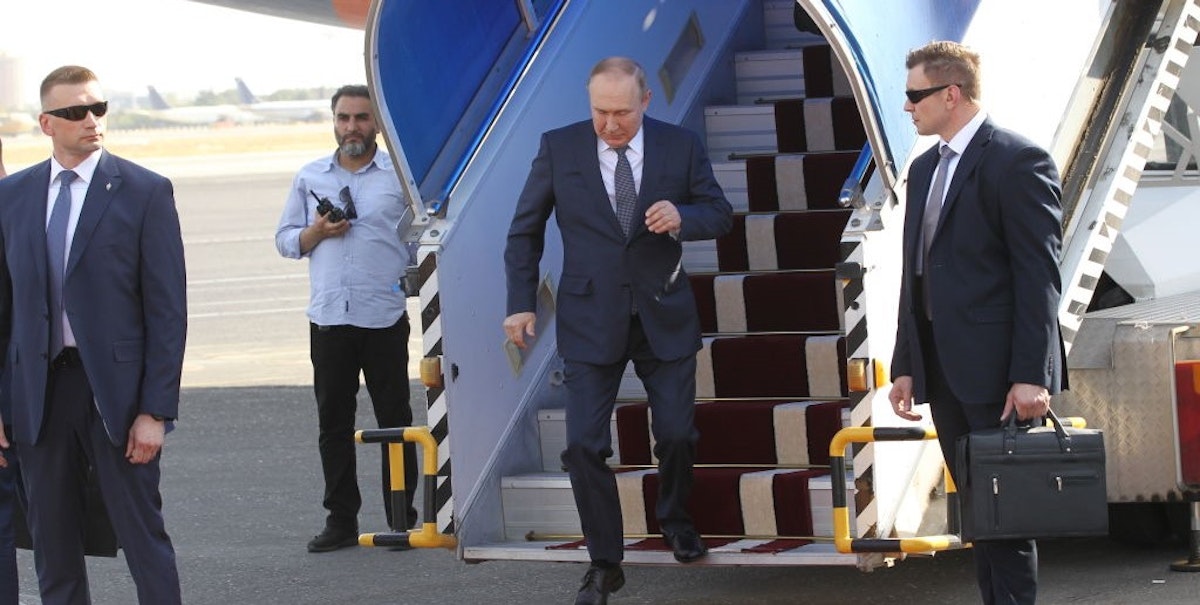 WATCH: Putin Hobbles Down Red Carpet With Arm Hanging Limp On Iran Trip