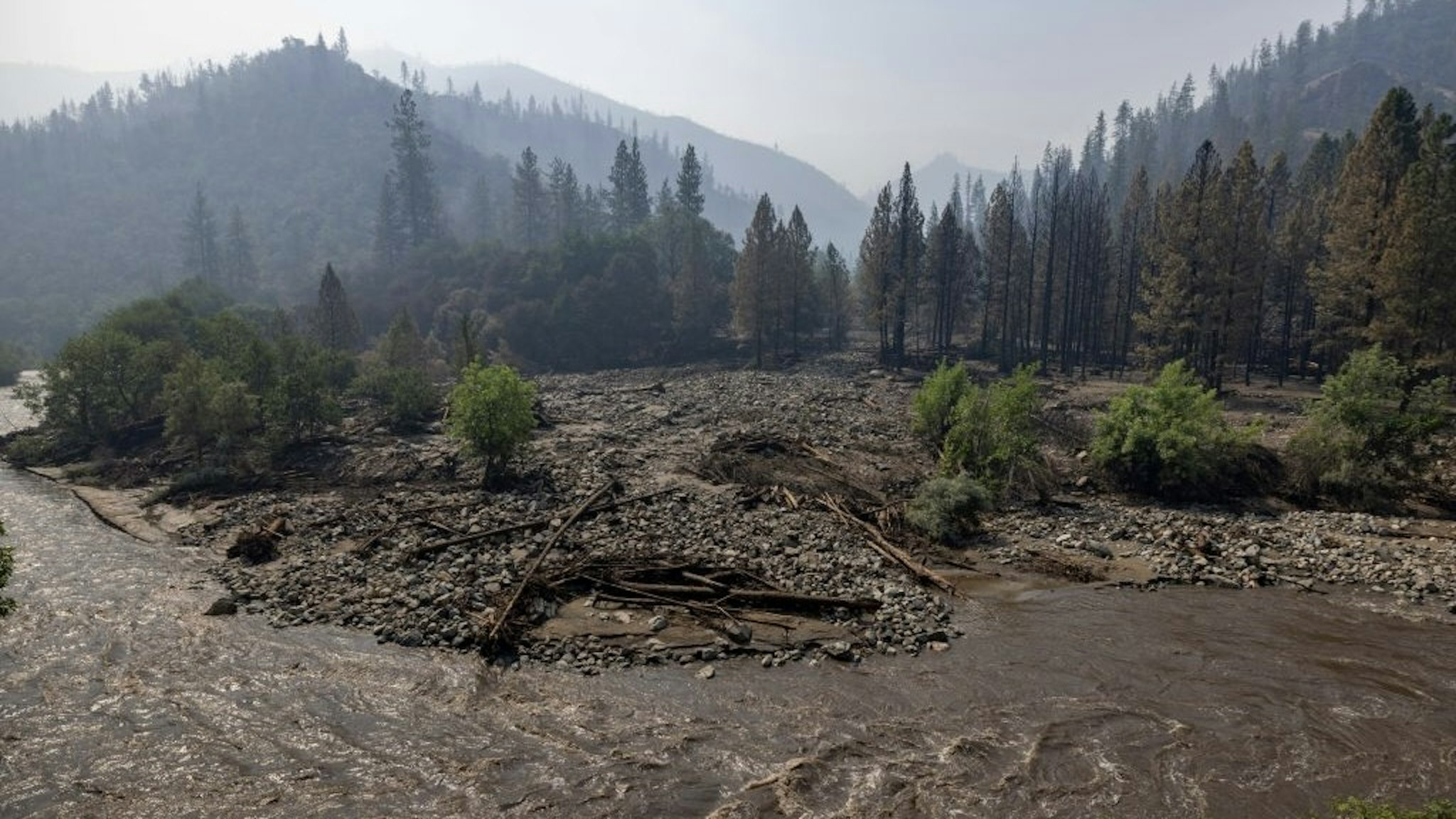 US-ENVIRONMENT-CALIFORNIA-FIRE The Klamath River runs brown with mud after flash floods hit the McKinney Fire in the Klamath National Forest near Yreka, California, on August 3, 2022. - At least four people are now known to have died in a wildfire sweeping through California, authorities said on August 2, as they warned the toll from the state's worst blaze this year could rise further. The fire, which is burning in the Klamath National Forest near the border with Oregon, is California's largest this year, having consumed around 56,000 acres (22,600 hectares). (Photo by DAVID MCNEW / AFP) (Photo by DAVID MCNEW/AFP via Getty Images) DAVID MCNEW / Contributor