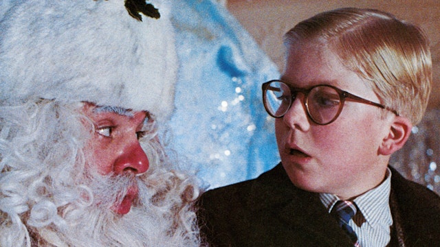 Peter Billingsley sits on Santa's lap in a scene from the film 'A Christmas Story', 1983.