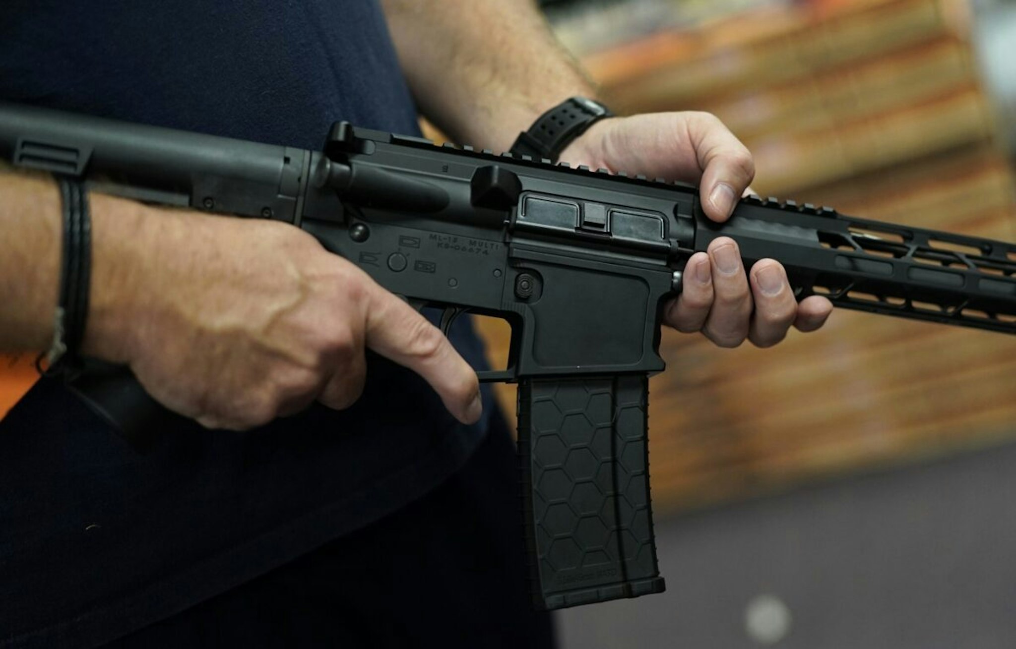 A customer handles an AR-15 at Jimmy's Sport Shop in Mineola, New York on September 25, 2020