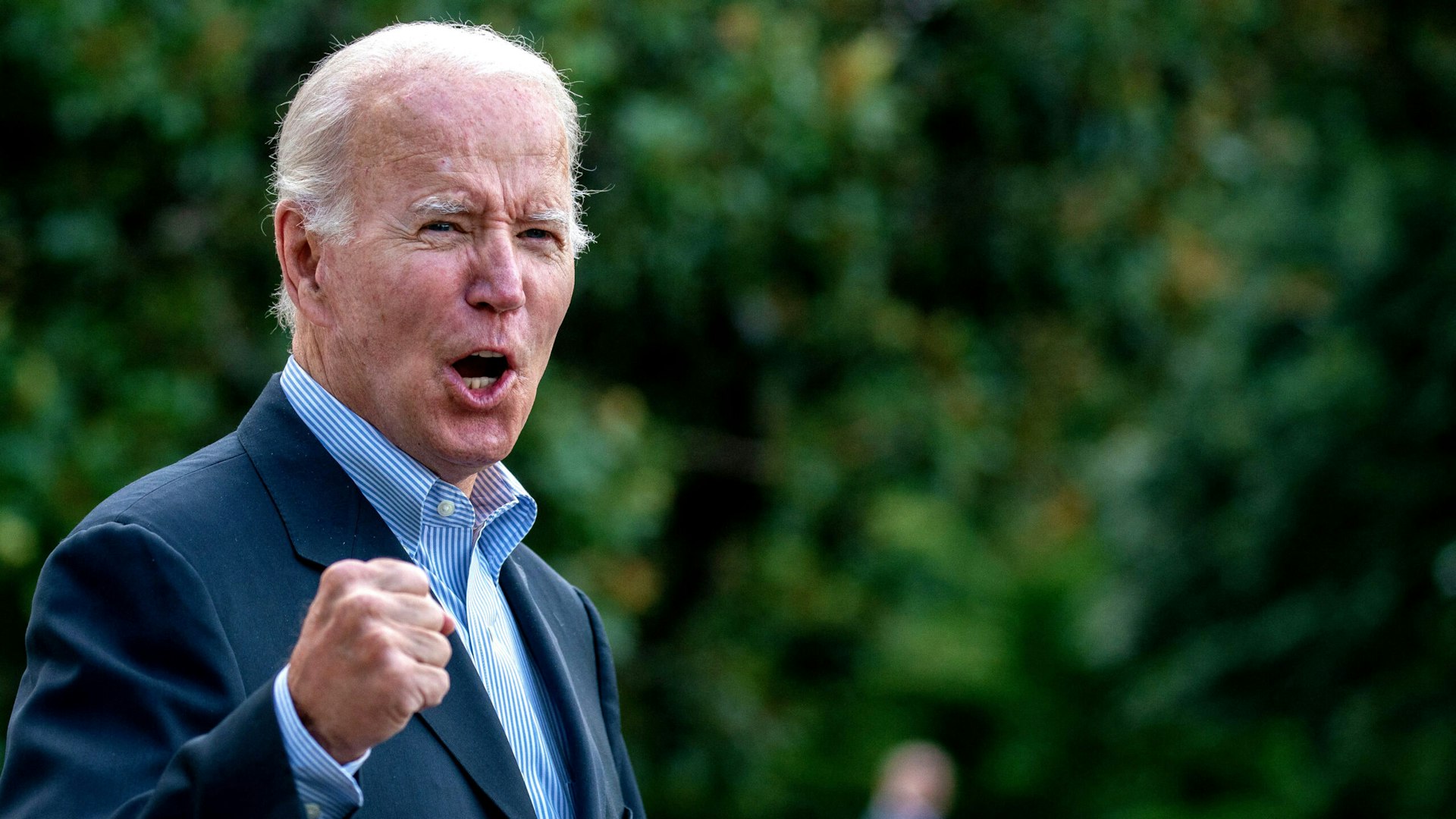 TOPSHOT - US President Joe Biden answers a shouted question from a reporter while walking to Marine One on the South Lawn of the White House in Washington, DC, on August 7, 2022, as he travels to Rehoboth Beach, Delaware.