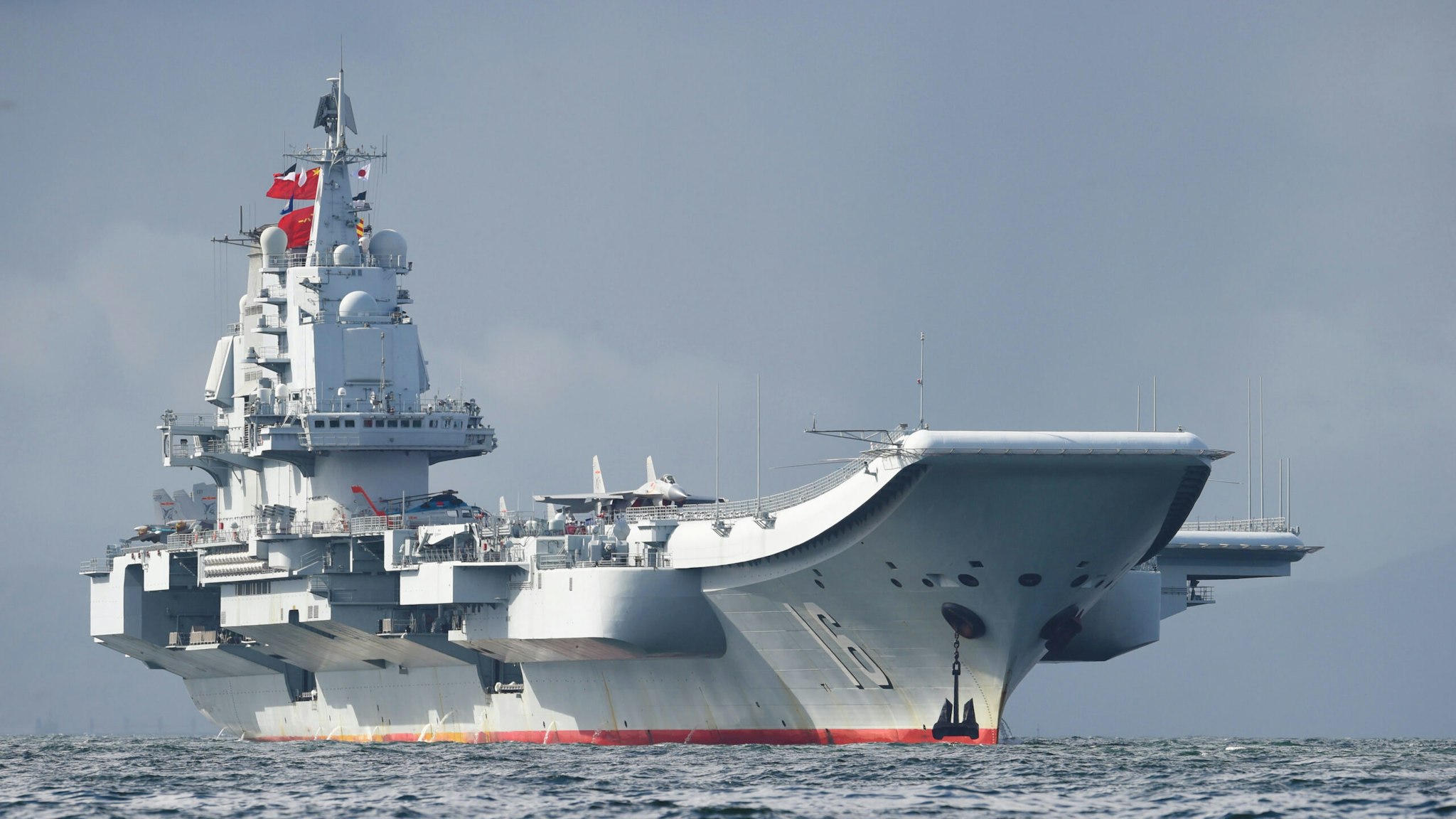 China's sole aircraft carrier, the Liaoning, arrives in Hong Kong waters on July 7, 2017, less than a week after a high-profile visit by president Xi Jinping. China's national defence ministry had said the Liaoning, named after a northeastern Chinese province, was part of a flotilla on a "routine training mission" and would make a port of call in the former British colony.