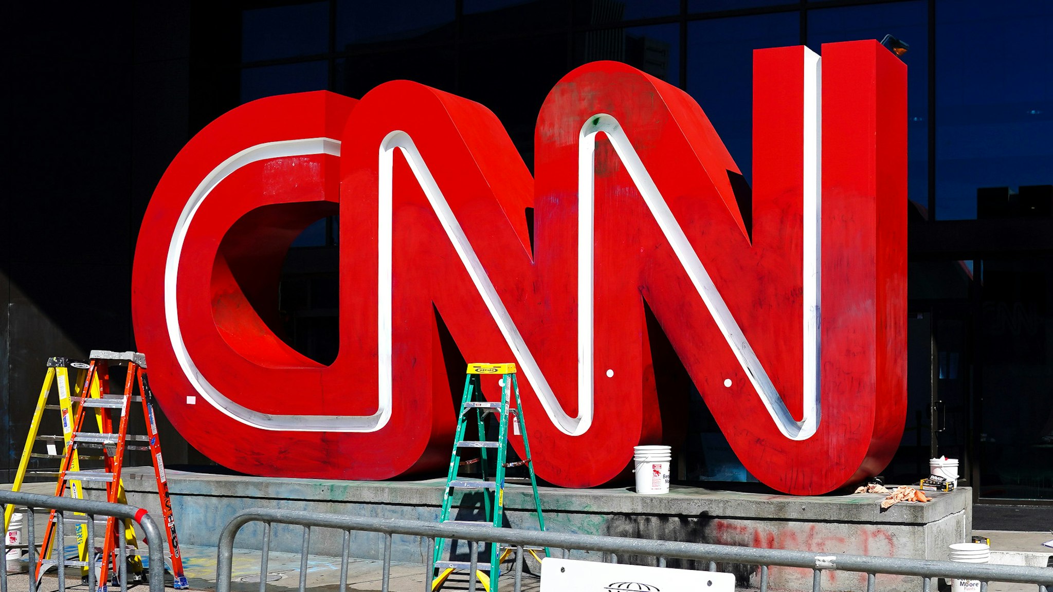 ATLANTA, GA - MAY 30: A woman takes a photo of the CNN sign following an overnight demonstration over the Minneapolis death of George Floyd while in police custody on May 30, 2020 in Atlanta, Georgia. Demonstrations are being held across the U.S. after George Floyd died in police custody on May 25th in Minneapolis, Minnesota.