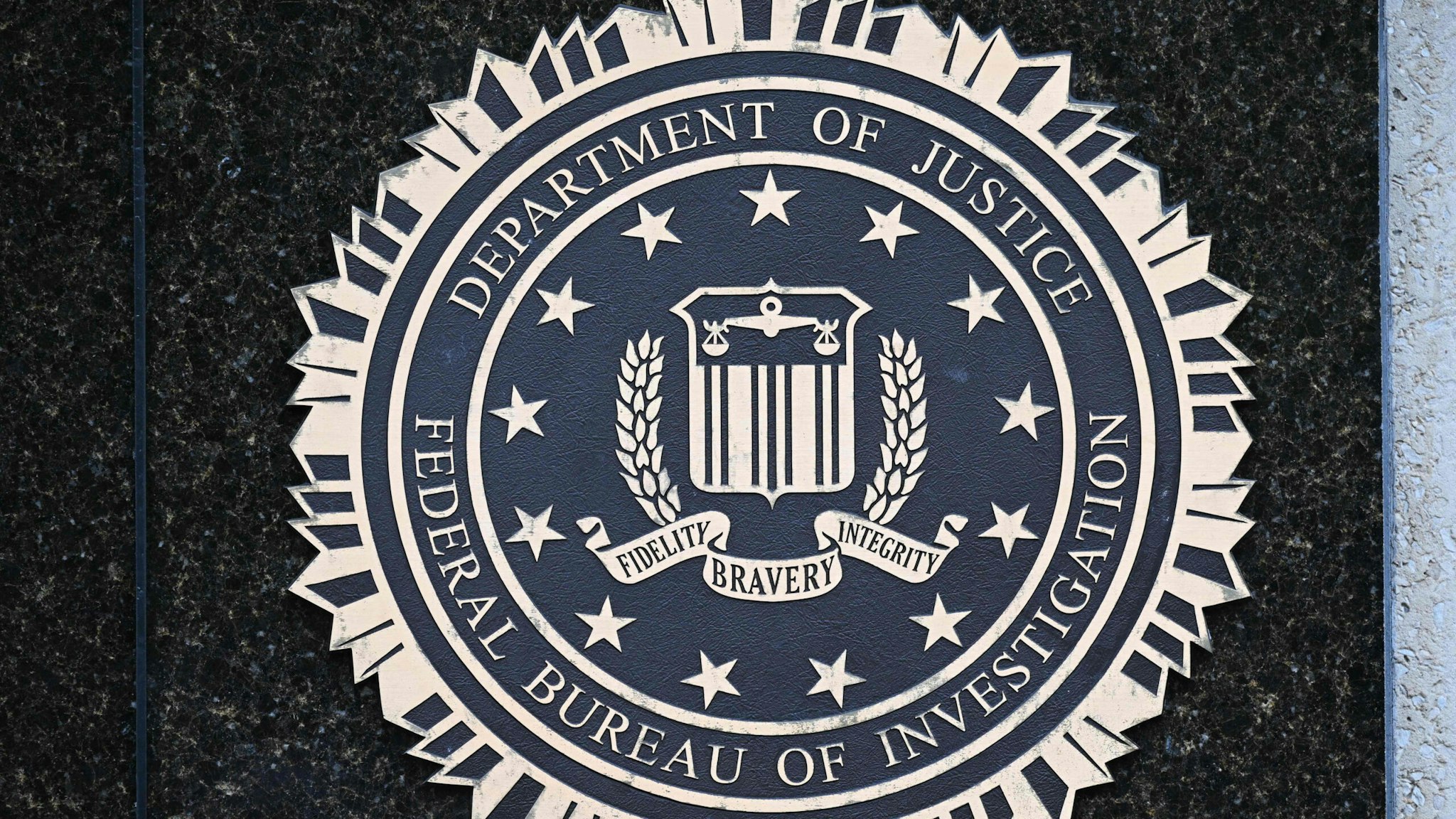 The seal of the Federal Bureau of Investigation is seen outside of its headquarters in Washington, DC on August 15, 2022. - Threats against the FBI and law enforcement agencies have increased following the search and seizure of top secret documents from former US president Donald Trump's Mar-a-Lago estate where he resides.