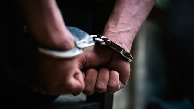 Cropped Hand Of Handcuffs - stock photo