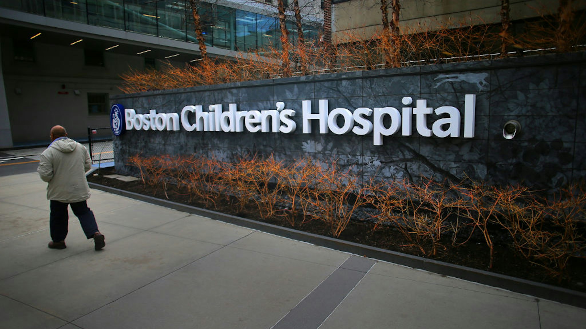 Boston, MA - February 26: A pedestrian passes the Longwood Avenue exterior of the Boston Children's Hospital on February 26, 2020. (Photo by Lane Turner/The Boston Globe via Getty Images)