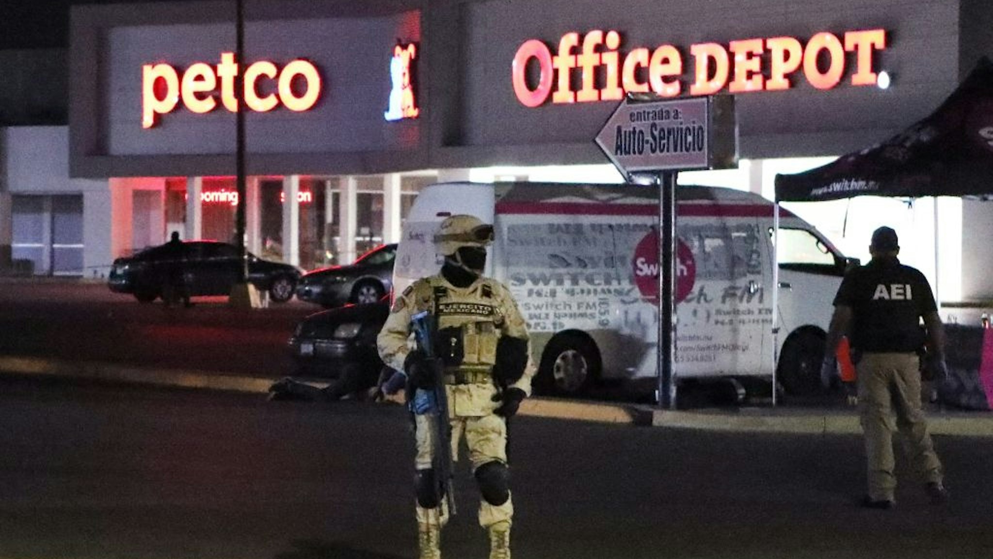 Members of the Mexican Army and forensic experts work at the site where four radio station workers were killed and two restaurant employees were wounded in Ciudad Juarez, state of Chihuahua, Mexico, on August 11, 2022.