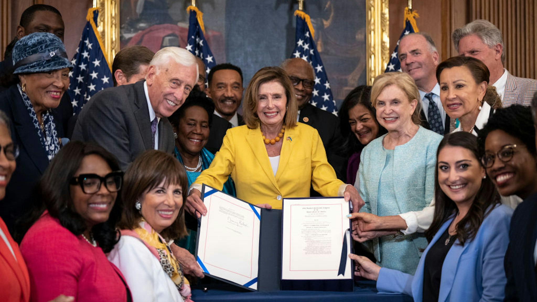 WASHINGTON, DC - AUGUST 12: House Democrats pose for photos after Speaker of the House Nancy Pelosi (D-CA) signed the Inflation Reduction Act during a bill enrollment ceremony after the House passed the legislation at the U.S. Capitol August 12, 2022 in Washington, DC. The $737 billion legislation will focus on slowing climate change, lower health care costs and creating clean energy jobs by enacting a 15% corporate minimum tax, a 1% fee on stock buybacks and enhancing IRS enforcement. (Photo by Drew Angerer/Getty Images)