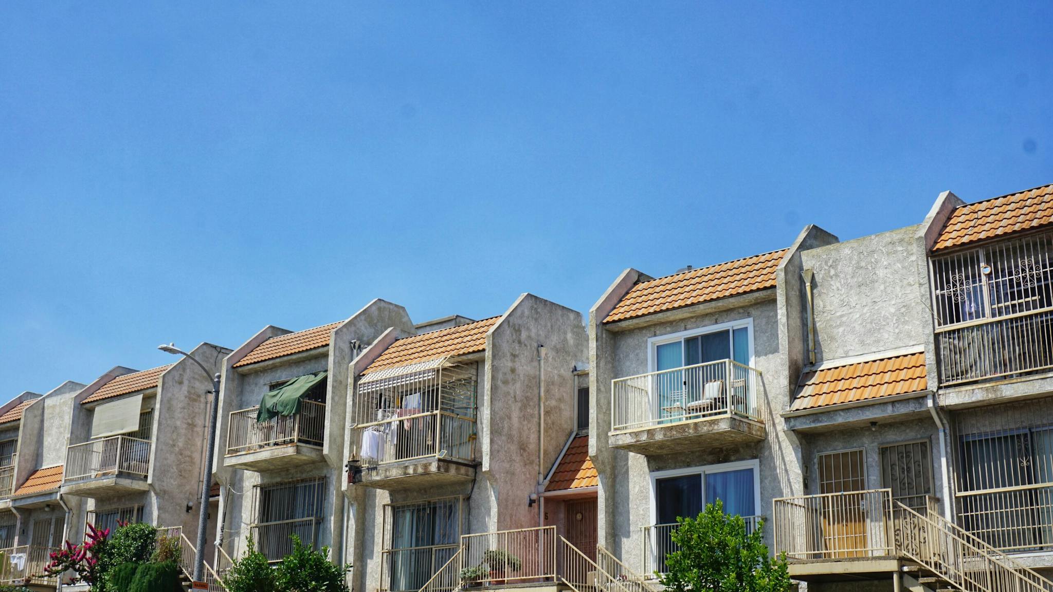 Low Angle View Of Townhouses Against Blue Sky