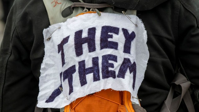 A protestor wears a piece of fabric with the pronouns 'they/them' pinned to them as Minneasotans hold a rally to raise awareness of the increasing number of attacks on transgender children, at the Capitol in the St Paul area of Minnesota, Texas, 6th March 2022. (Photo by: Michael Siluk/UCG/Universal Images Group via Getty Images)