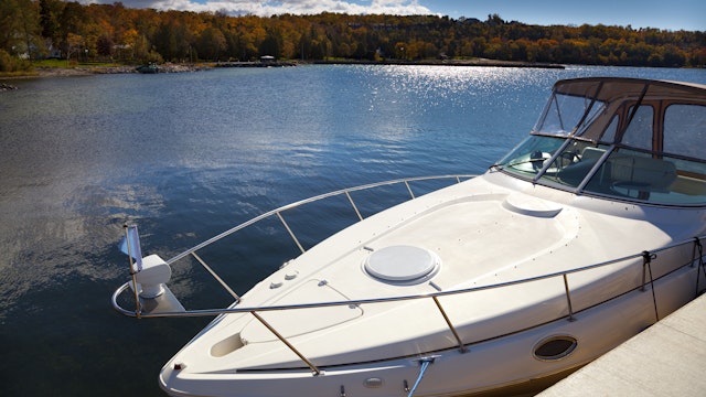 Luxury Boat Moored in Sunny Autumn Harbor - stock photo