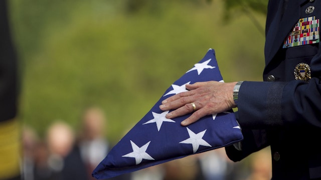 Soldier folding flag at military funeral