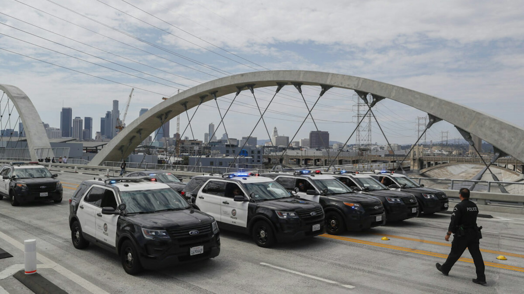Los Angeles, CA, Sunday, July 31, 2022 - LAPD officers gather to sweep a bike club off the Sixth Street Viaduct while in the midst of a traffic enforcement operation from 2pm to 10pm