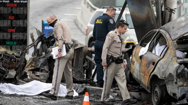 LOS ANGELES, CA - AUGUST 04: CHP and other officials investigate a fiery crash where multiple people were killed near a Windsor Hills gas station at the intersection of West Slauson and South La Brea avenues on Thursday, Aug. 4, 2022 in Los Angeles, CA.