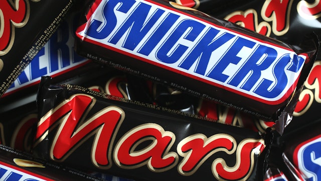 BERLIN, GERMANY - FEBRUARY 23: In this photo illustration Snickers and Mars chocolate bars lie on a table on February 23, 2016 in Berlin, Germany. The Mars company, which owns both brands, has announced a recall of chocolate products in 55 countries following the discovery of bits of plastic in a chocolate bar produced in one of the company's plants in Holland.