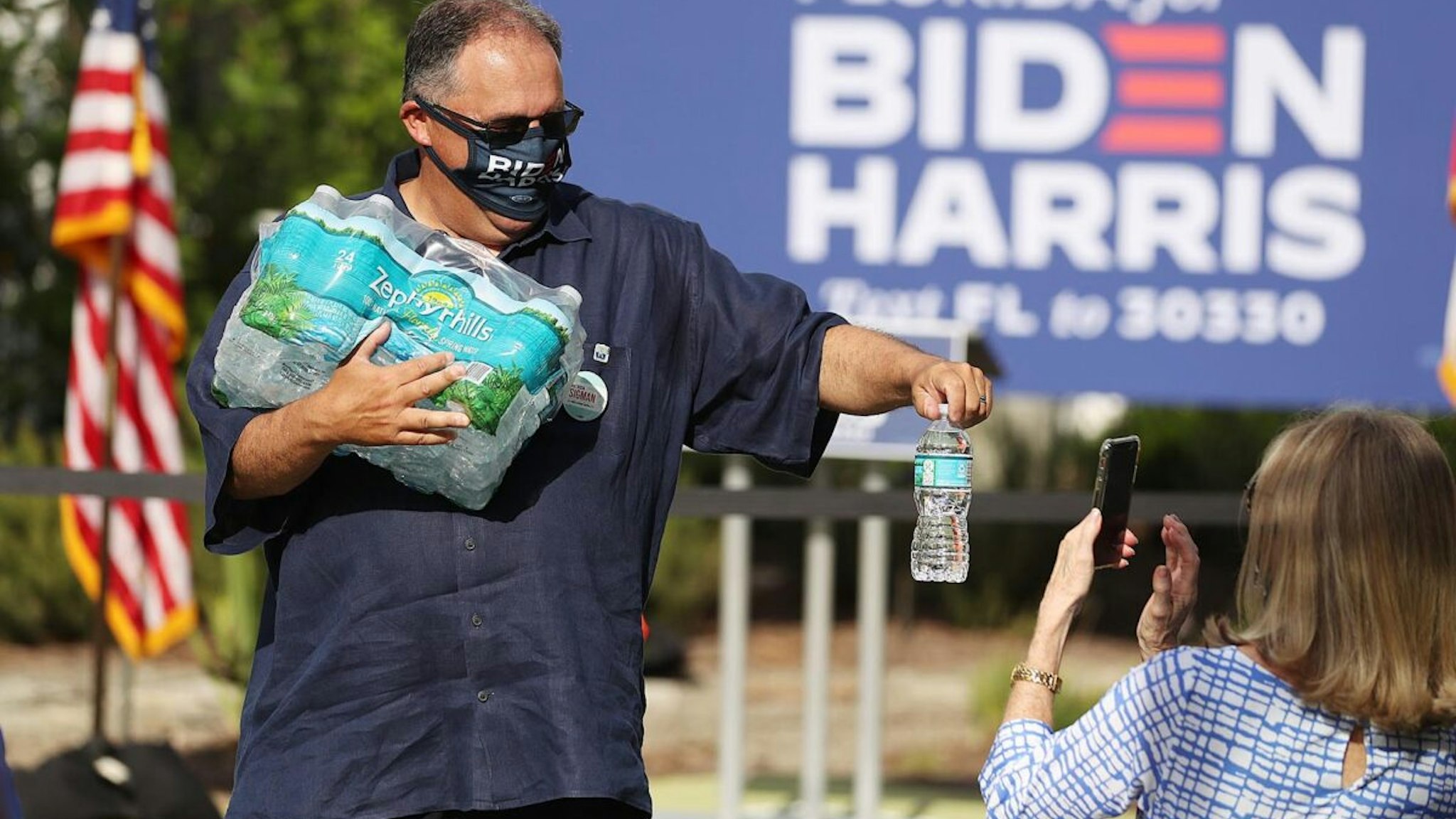 Stan Van Gundy hands out water to guests before a Women for Biden event at Van Gundys home in Lake Mary on Friday,October 16, 2020