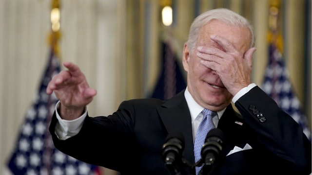 U.S. President Joe Biden covers his eyes to choose a reporter to ask a question after speaking on the passage of the Bipartisan Infrastructure Deal in the State Dining Room of the White House in Washington, D.C., U.S., on Saturday, Nov. 6, 2021.