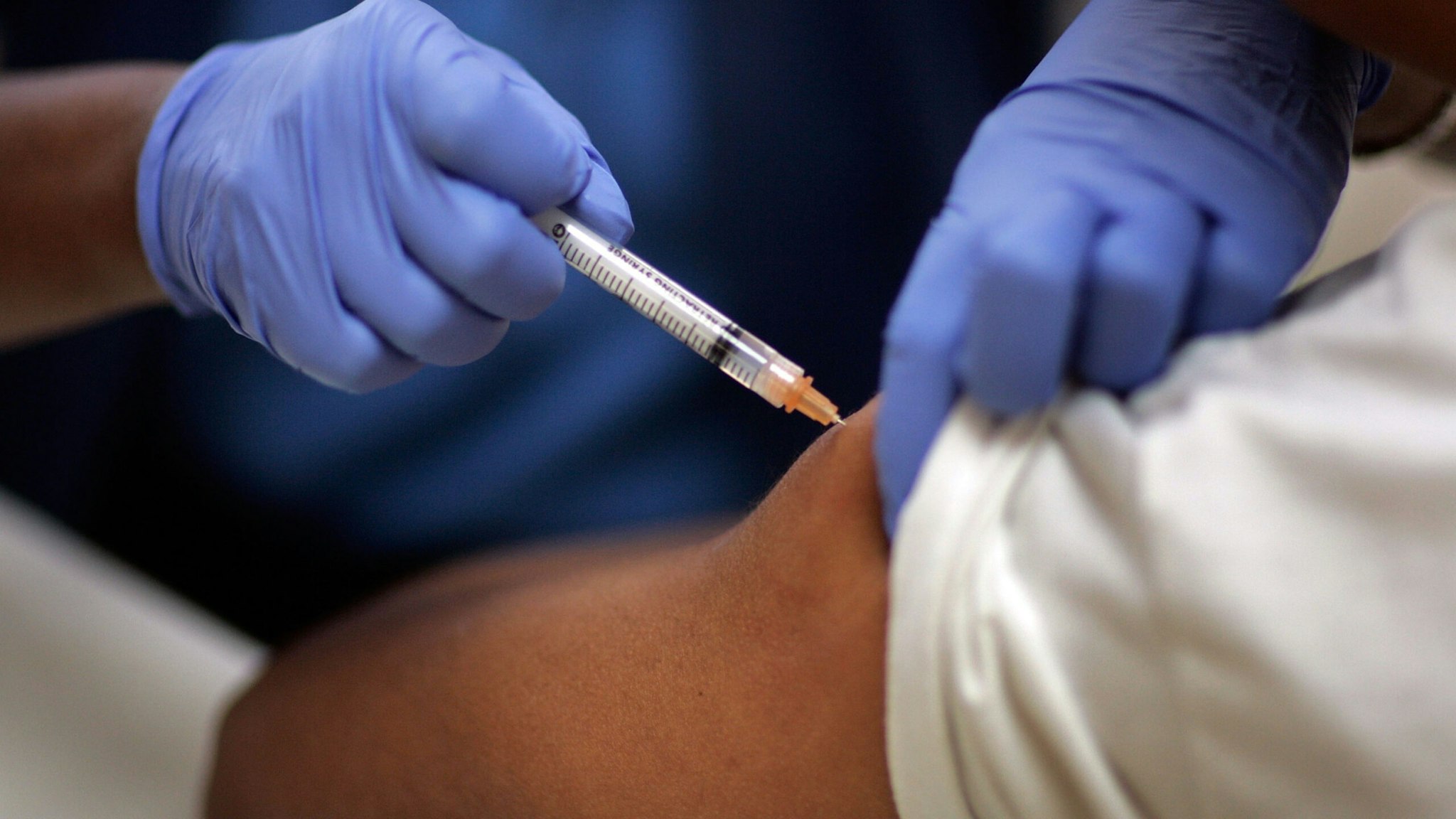 Josette Thomas, a school nurse, gives a child an immunization shot August 8, 2007 in Hialeah, Florida.