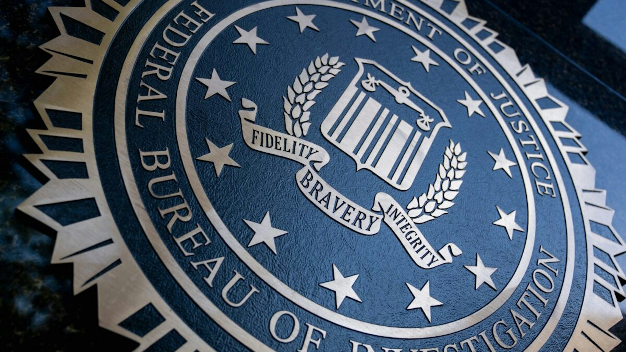 A seal reading "Department of Justice Federal Bureau of Investigation" is displayed on the J. Edgar Hoover FBI building in Washington, DC, o August 9, 2022