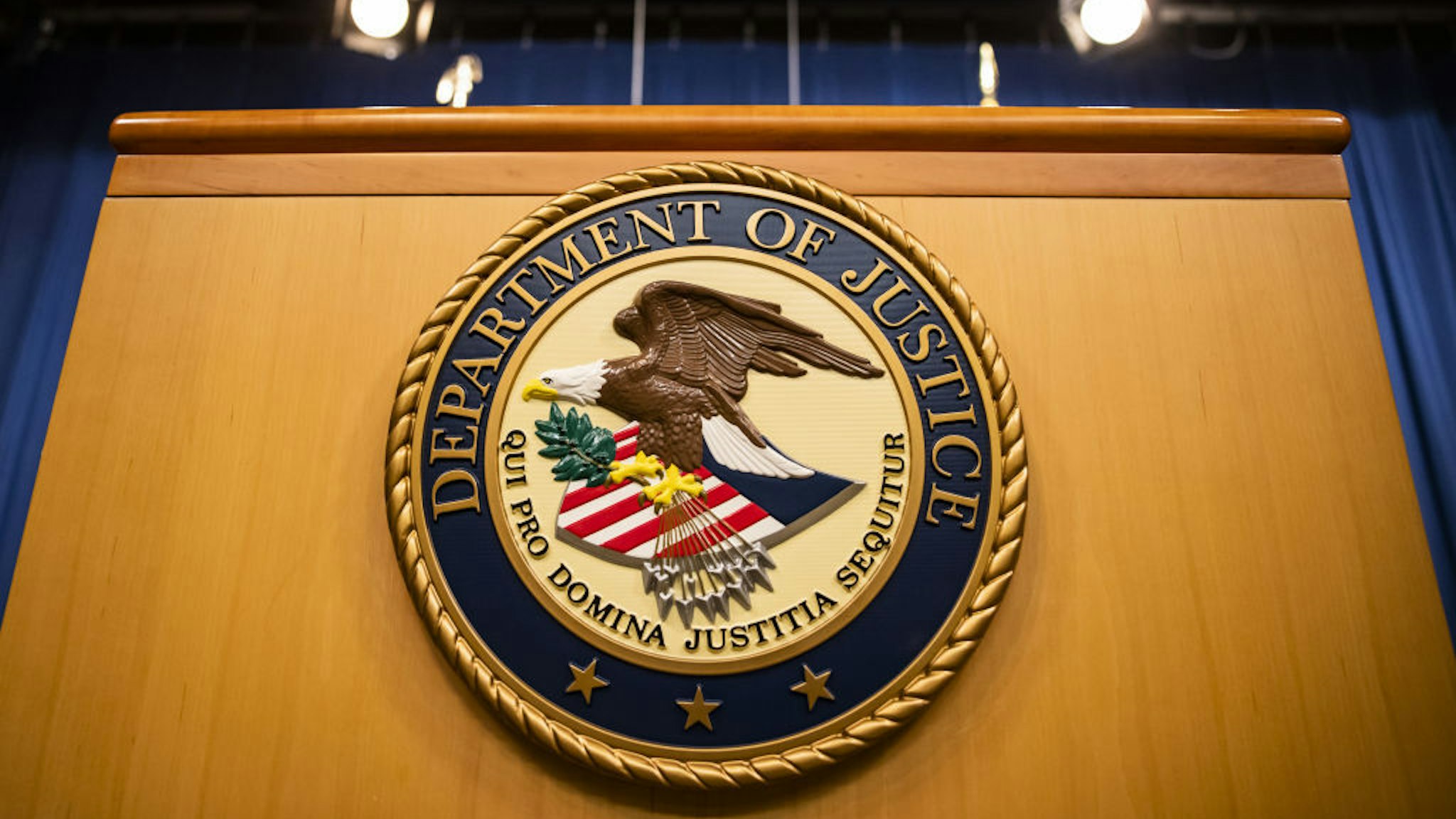 The U.S. Department of Justice seal on a podium in Washington, D.C., U.S., on Thursday, Aug. 5, 2021. The Justice Department has opened an investigation into the City of Phoenix and the Phoenix Police Department looking into types of use of force by Phoenix police department officers. Photographer: Samuel Corum/Bloomberg