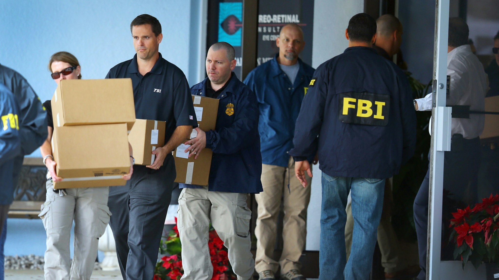 WEST PALM BEACH, FL - JANUARY 30: FBI agents carry out boxes as law enforcement officials investigate the medical-office complex of Dr. Salomon Melgen who has possible ties to U.S. Sen. Bob Menendez (D-NJ) on January 30, 2013 in West Palm Beach, Florida. The agents arrived last night at the medical-office complex and started hauling away potential evidence in several vans.