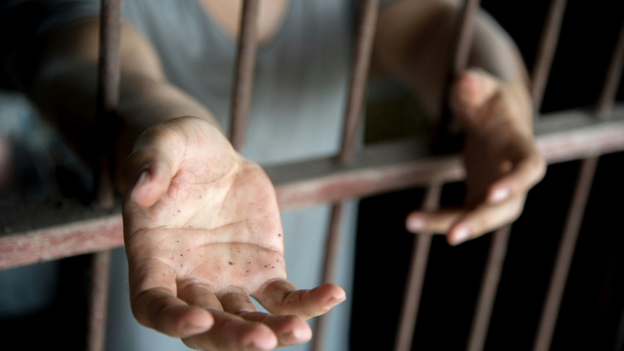 Midsection Of Woman Standing In Prisoner - stock photo