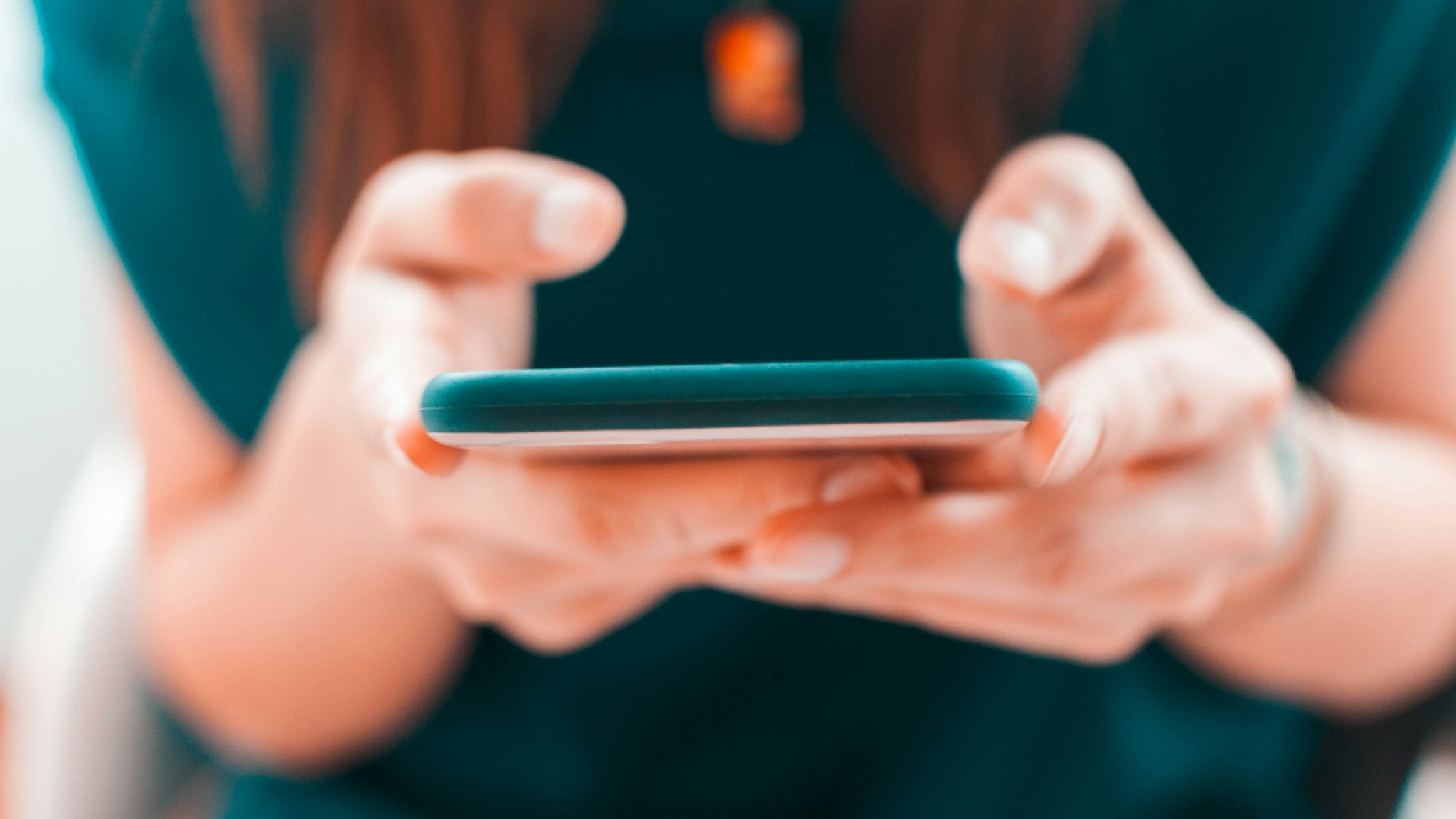 A young woman is using her smartphone - stock photo