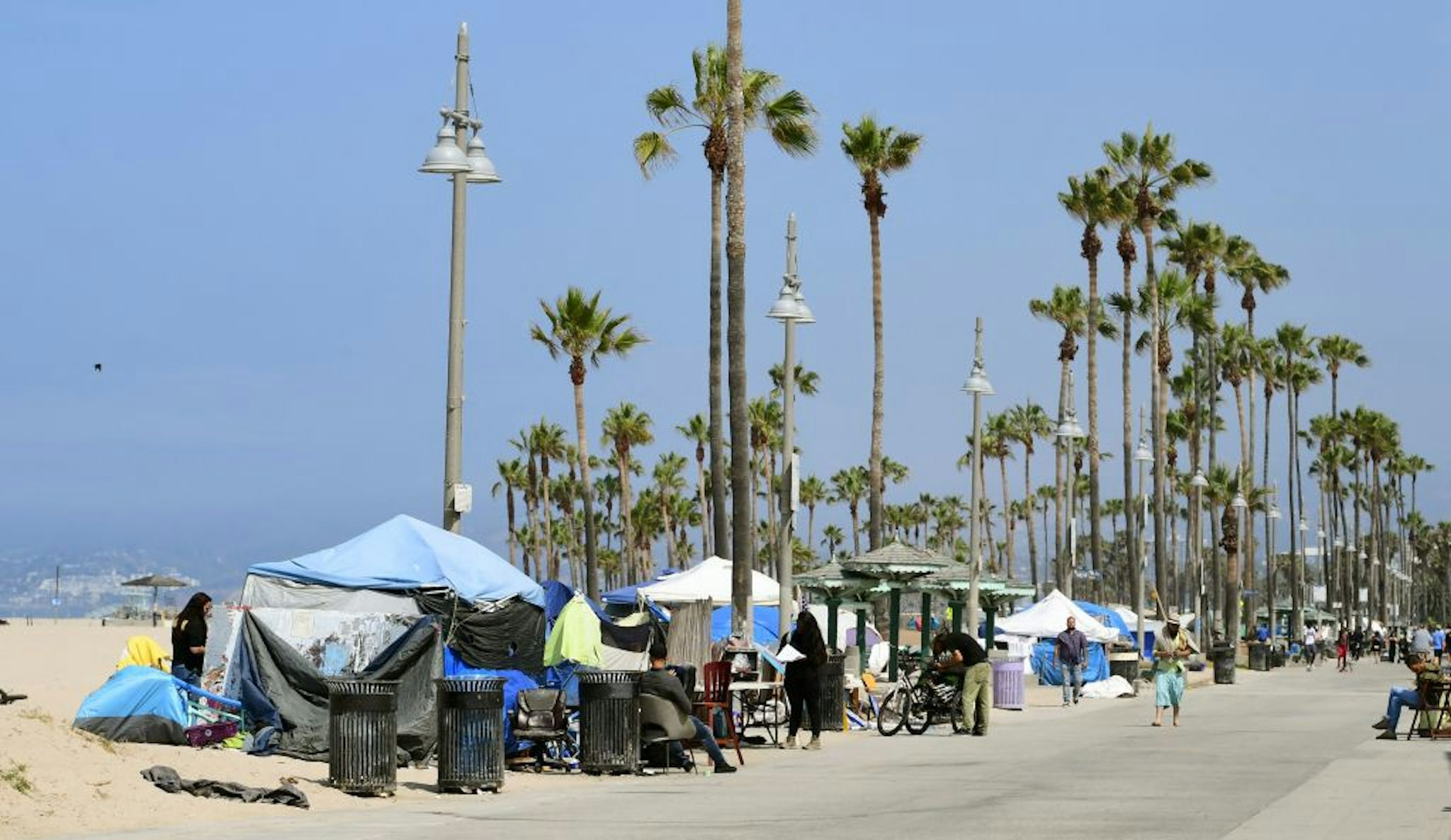 Tents line the Ocean Front Walk on June 30, 2021 in Venice, California, where an initiative began this week offering people in homeless encampments a voluntary path to permanent housing. - Homeless encampments at the famed Venice Beach has grown during the coronavirus pandemic, turning into a political flashpoint, with signs posted on trees warning of a July 2 clearance of all homeless encampments ahead of the July 4th weekend. (Photo by Frederic J. BROWN / AFP) (Photo by FREDERIC J. BROWN/AFP via Getty Images)
