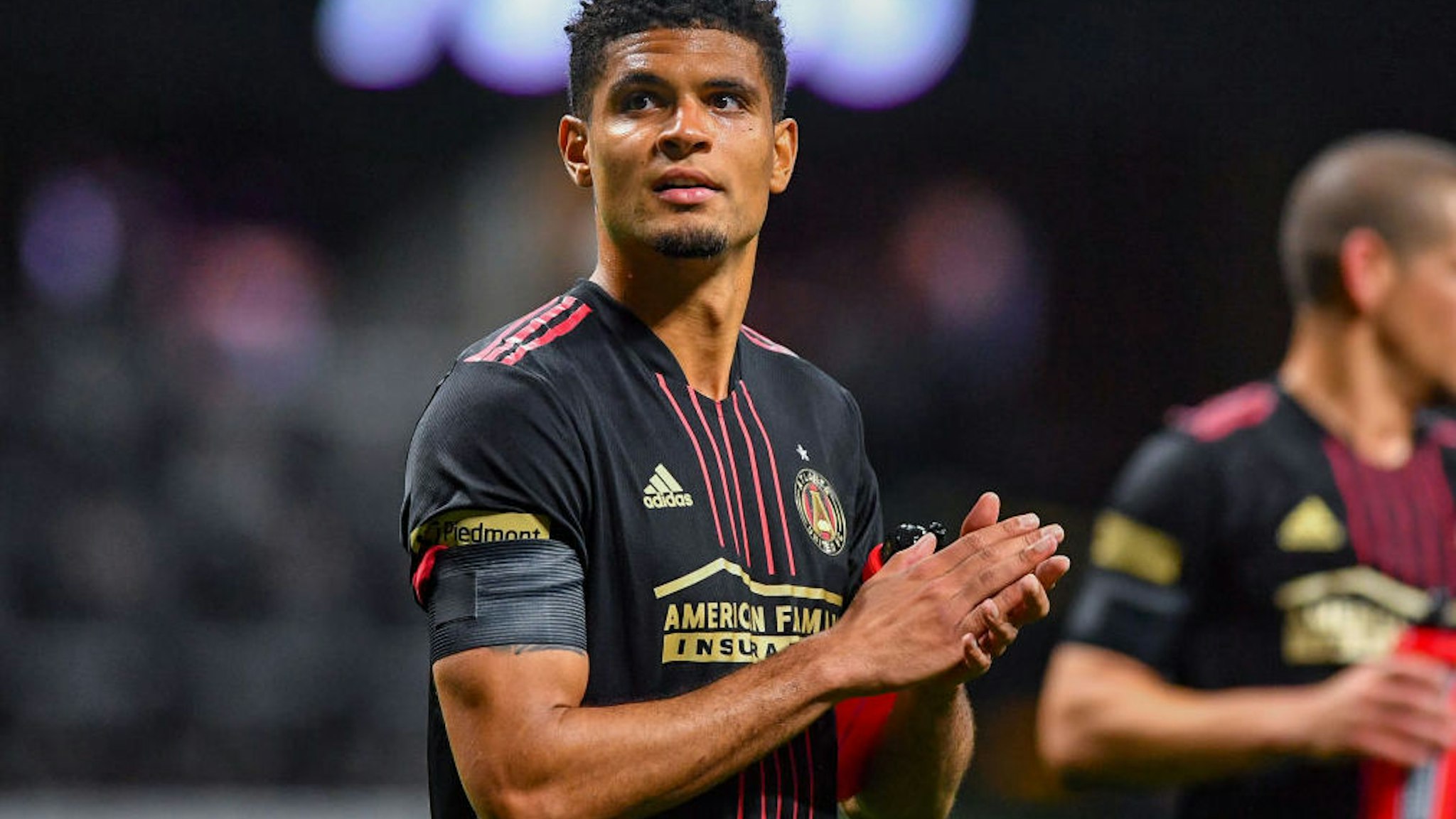 Atlanta defender Miles Robinson (12) thanks the fans following the conclusion of the MLS match between Sporting Kansas City and Atlanta United FC on February 27th, 2022 at Mercedes-Benz Stadium in Atlanta, GA.