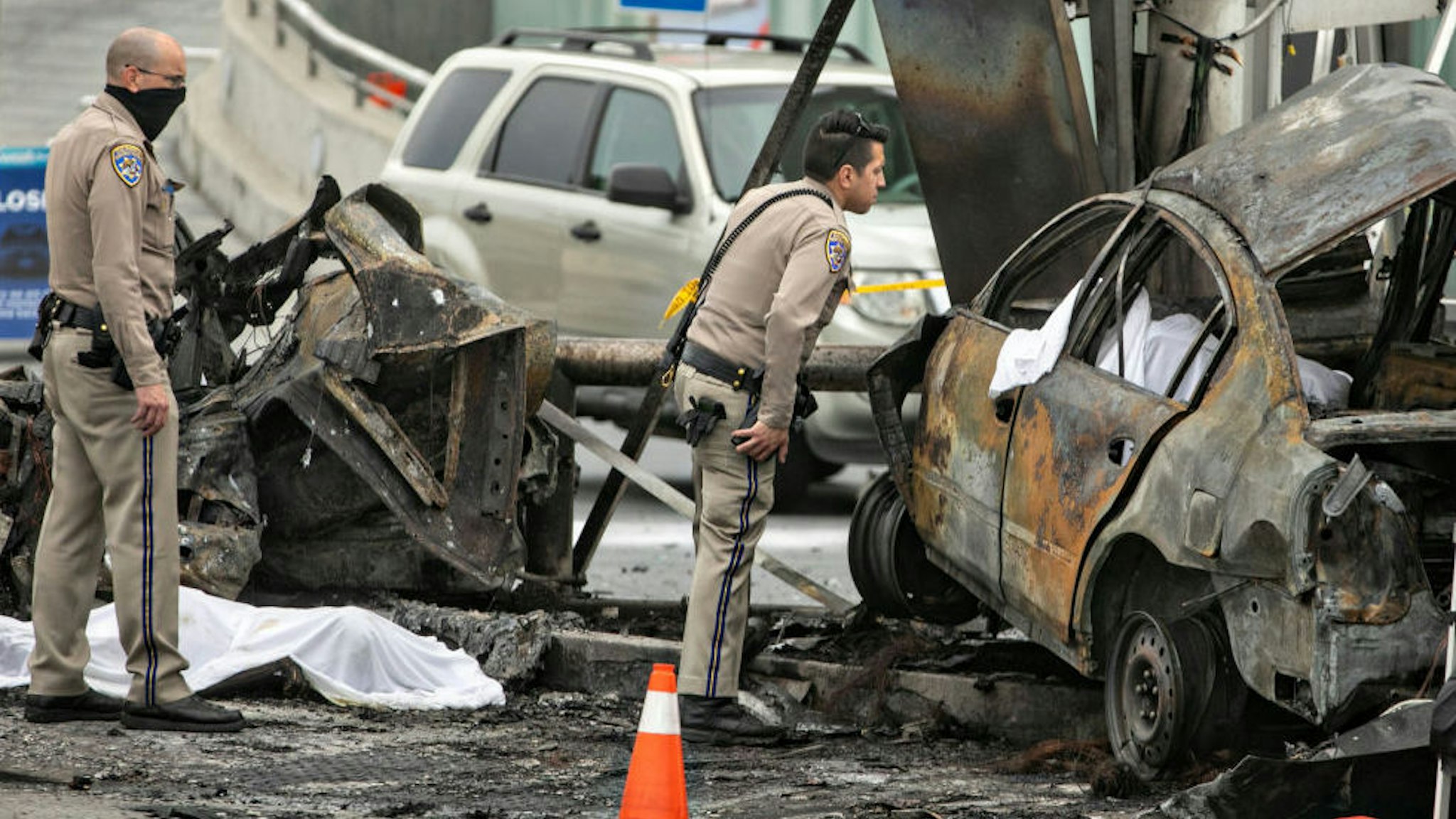 CHP and other officials investigate a fiery crash where multiple people were killed near a Windsor Hills gas station at the intersection of West Slauson and South La Brea avenues on Thursday, Aug. 4, 2022 in Los Angeles, CA.