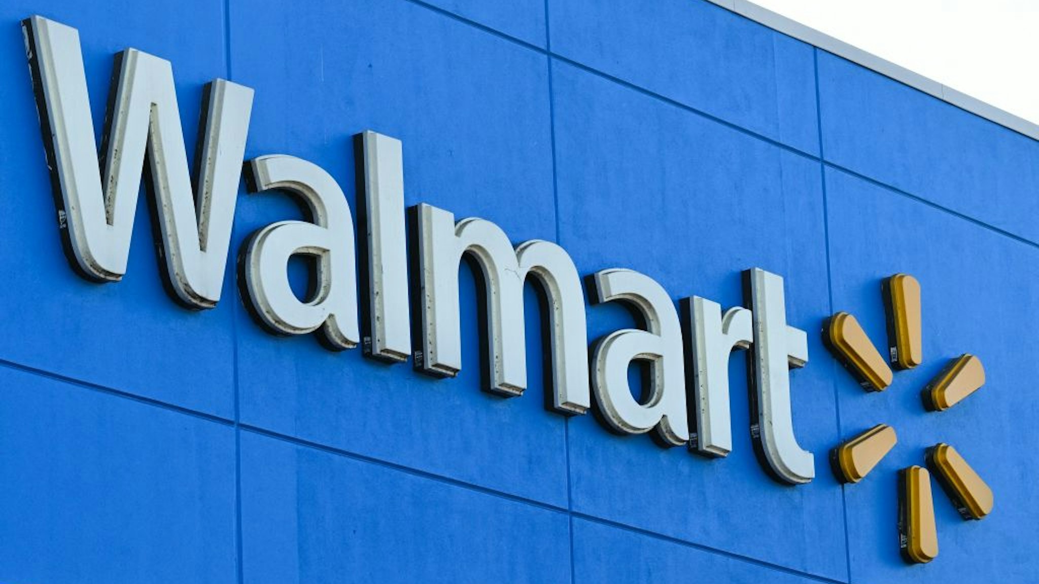 The Walmart logo is seen outside a Walmart store in Burbank, California on August 15, 2022. - Walmart, the largest retailer the United States, will report second quarter earnings on August 16, 2022. (Photo by Robyn Beck / AFP) (