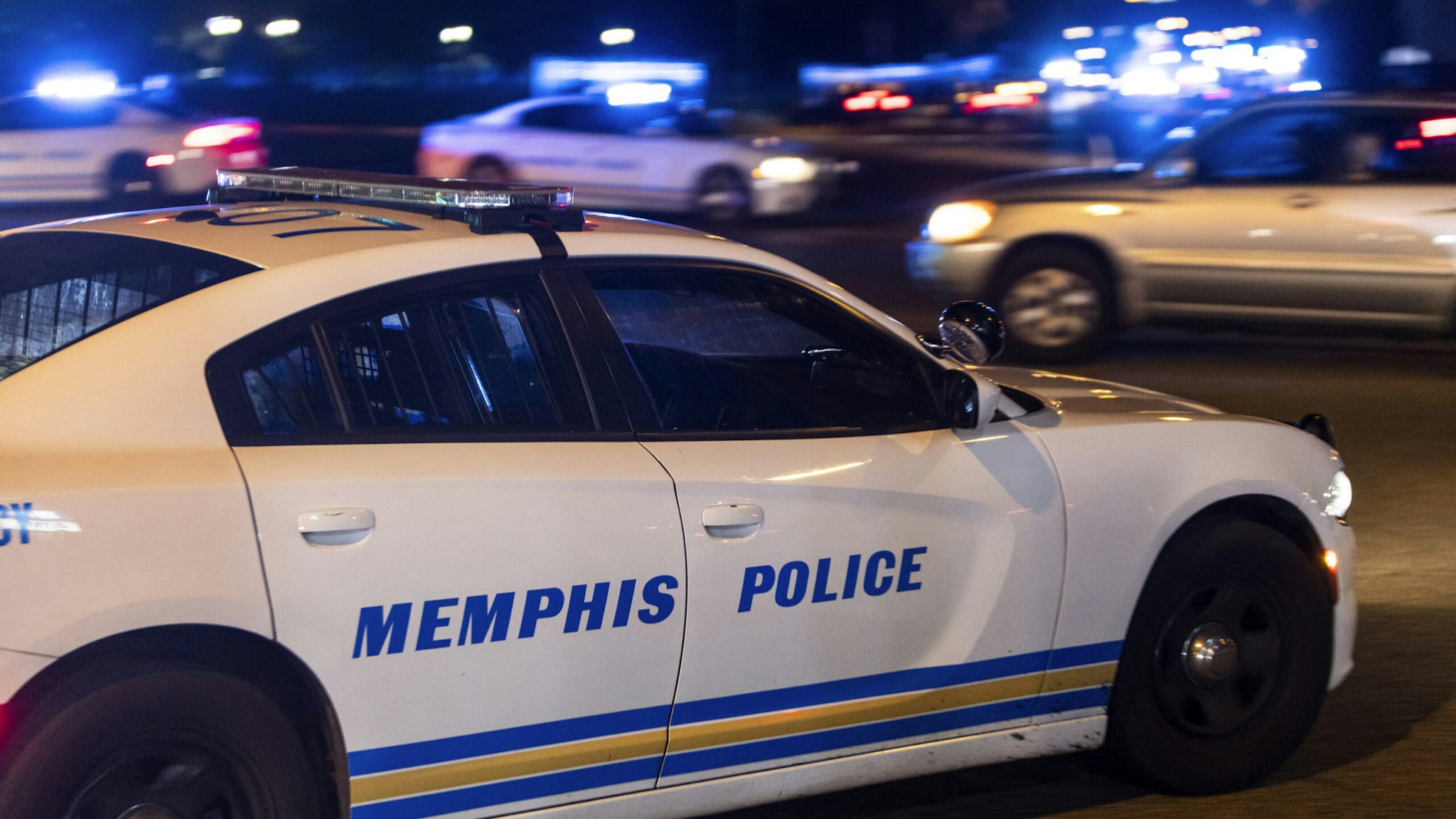 Police investigate the scene of a reported carjacking reportedly connected to a series of shootings on September 7, 2022 in Memphis, Tennessee. Memphis police arrested a 19-year-old man in connection with the shootings of multiple people across the city.