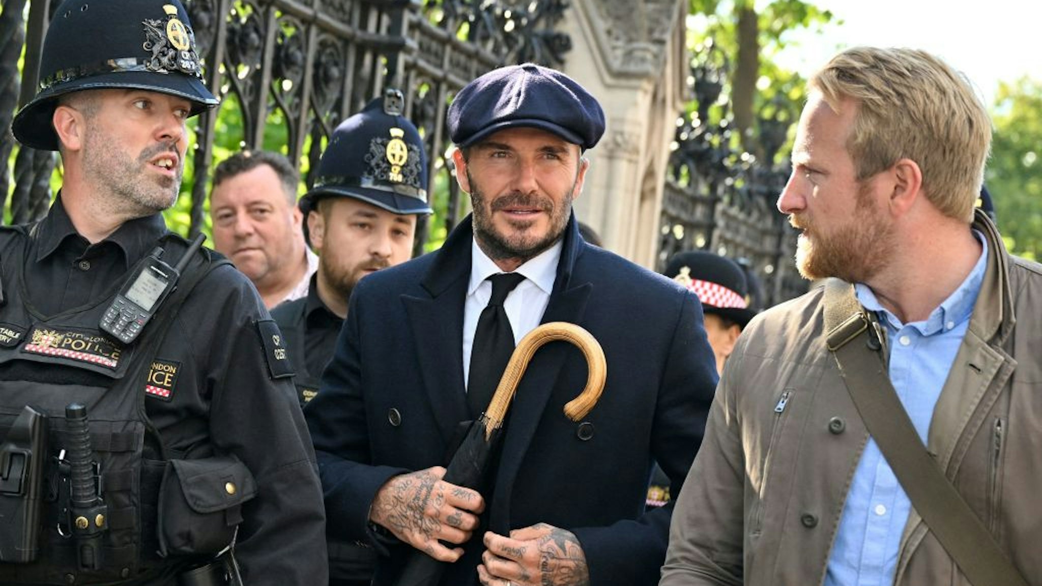 English former football player David Beckham leaves Westminster Hall, at the Palace of Westminster, in London on September 16, 2022 after paying his respects to the coffin of Queen Elizabeth II as it Lies in State. - Queen Elizabeth II will lie in state in Westminster Hall inside the Palace of Westminster, until 0530 GMT on September 19, a few hours before her funeral, with huge queues expected to file past her coffin to pay their respects. (Photo by Louisa Gouliamaki / AFP) (Photo by LOUISA GOULIAMAKI/AFP via Getty Images)