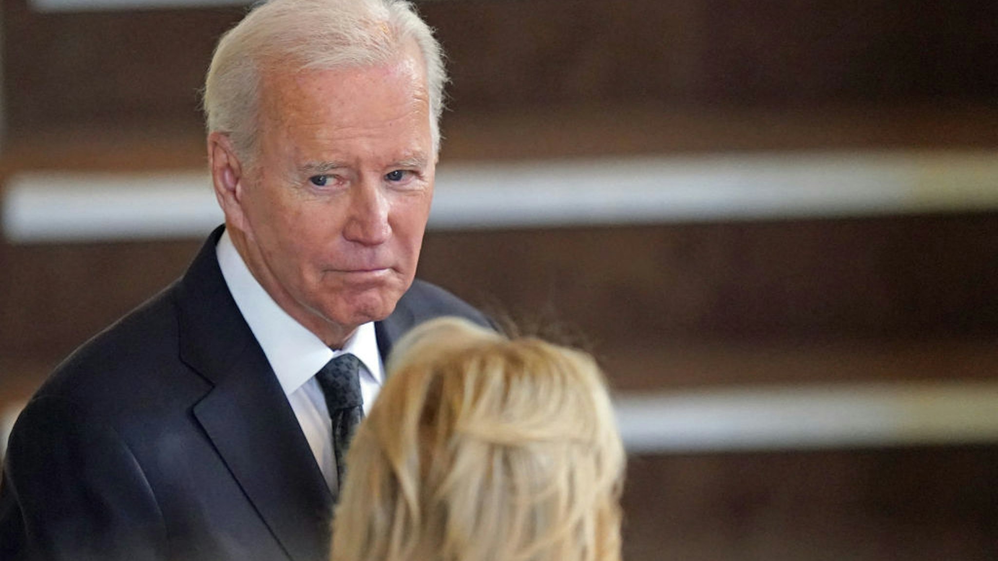 US President Joe Biden and First Lady Jill Biden pay their respects as they view the coffin of Queen Elizabeth II, as it Lies in State inside Westminster Hall, at the Palace of Westminster in London on September 18, 2022. - Queen Elizabeth II will lie in state in Westminster Hall inside the Palace of Westminster, until 0530 GMT on September 19, a few hours before her funeral, with huge queues expected to file past her coffin to pay their respects. (Photo by Jacob King / POOL / AFP) (Photo by JACOB KING/POOL/AFP via Getty Images)