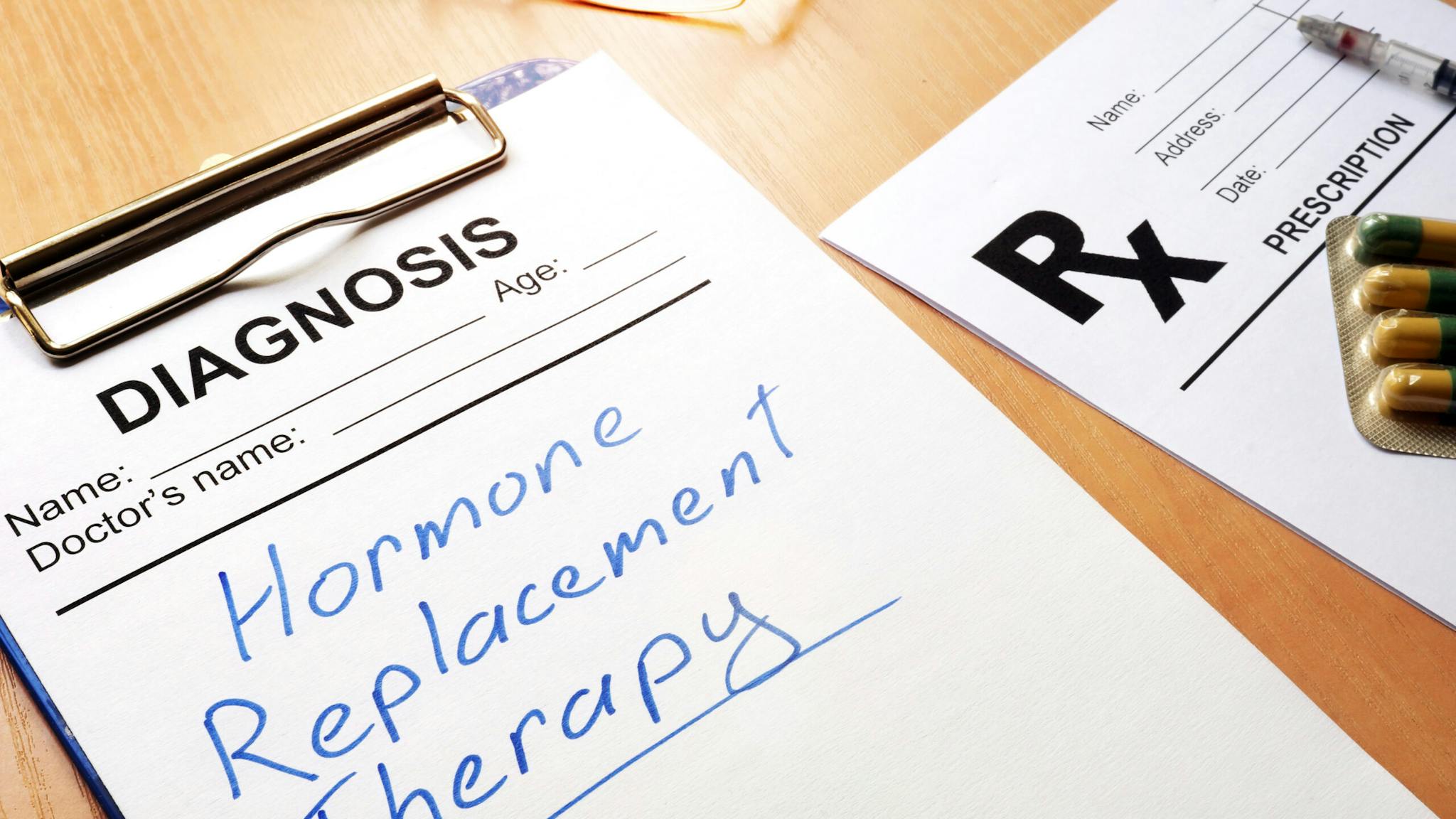Clipboard with medical form and sign Hormone Replacement Therapy.