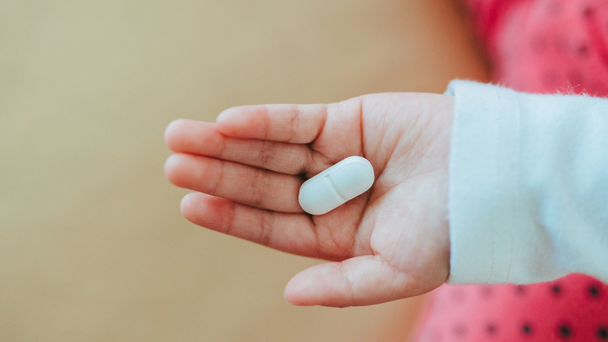 medical tablet pill on hand of a baby