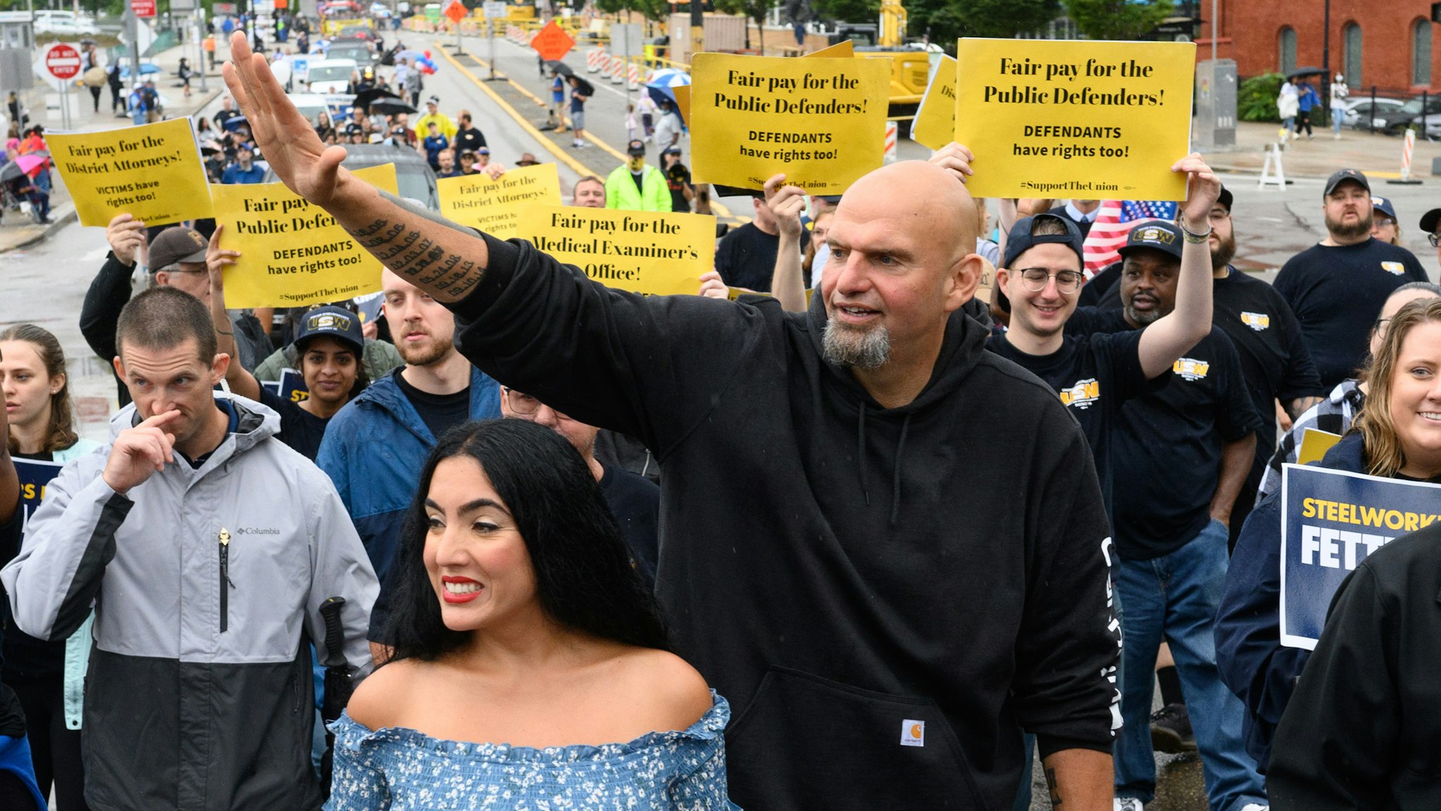 John Fetterman, lieutenant governor of Pennsylvania and Democratic senate candidate, center, and his wife Gisele Fetterman, center left, walk with the United Steelworkers District 10 union during a Labor Day parade in Pittsburgh, Pennsylvania, US, on Monday, Sept. 5, 2022. Pennsylvania is holding a number of high-profile election contests, including the open Senate seat race that is pitting Fetterman against Republican Mehmet Oz.