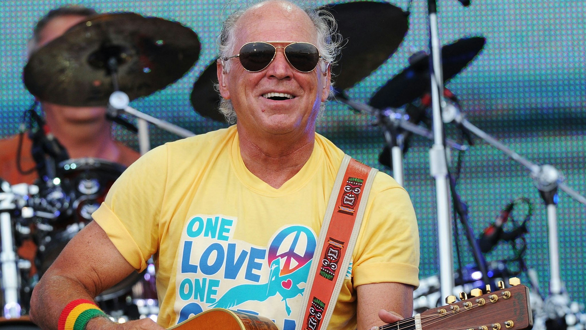 Musician Jimmy Buffett performs onstage at Jimmy Buffett & Friends: Live from the Gulf Coast, a concert presented by CMT at on the beach on July 11, 2010 in Gulf Shores, Alabama.