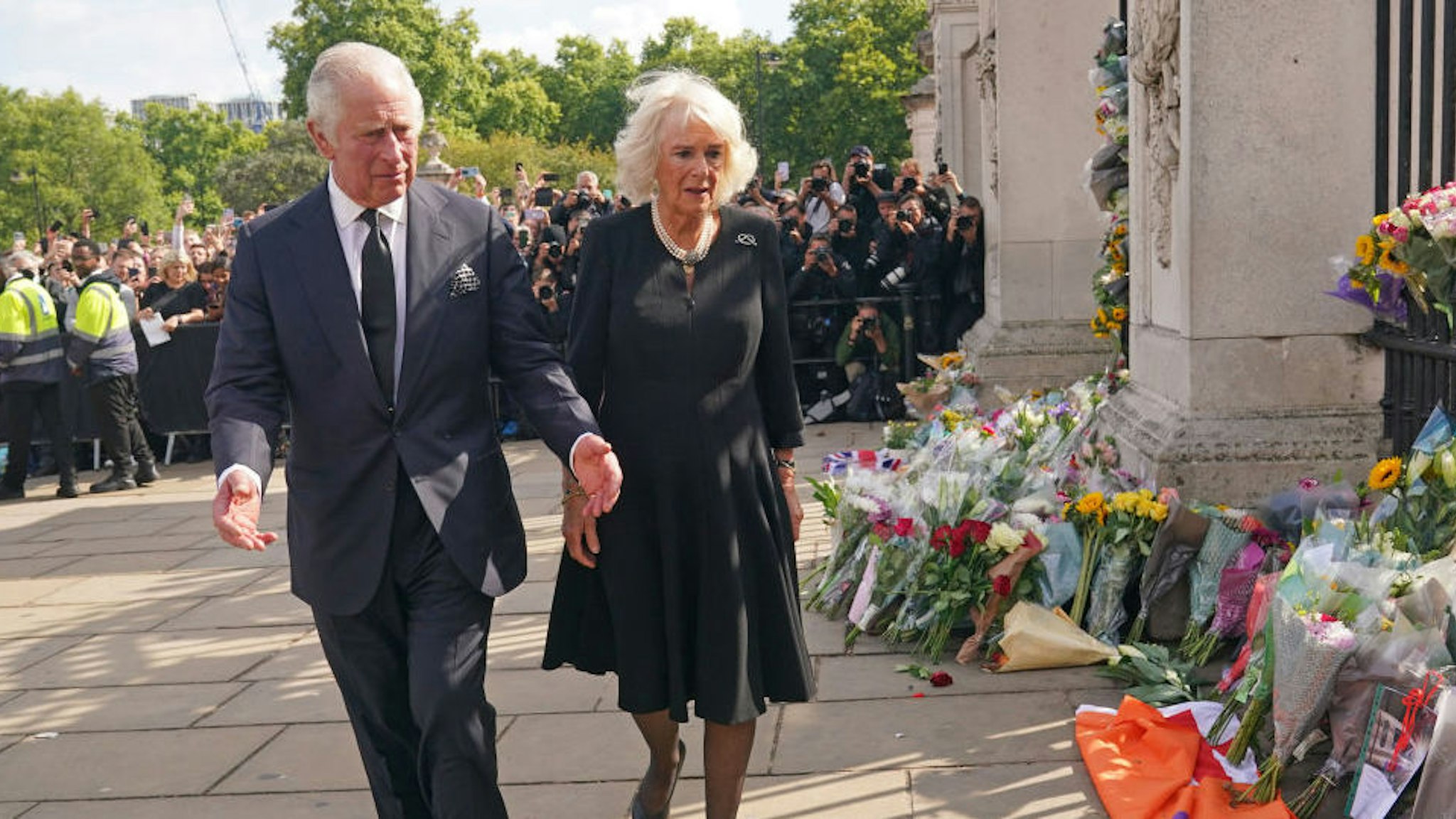 King Charles III and the Queen view tributes left outside Buckingham Palace, London, following the death of Queen Elizabeth II on Thursday. Picture date: Friday September 9, 2022. PA Photo. See PA story DEATH Queen.