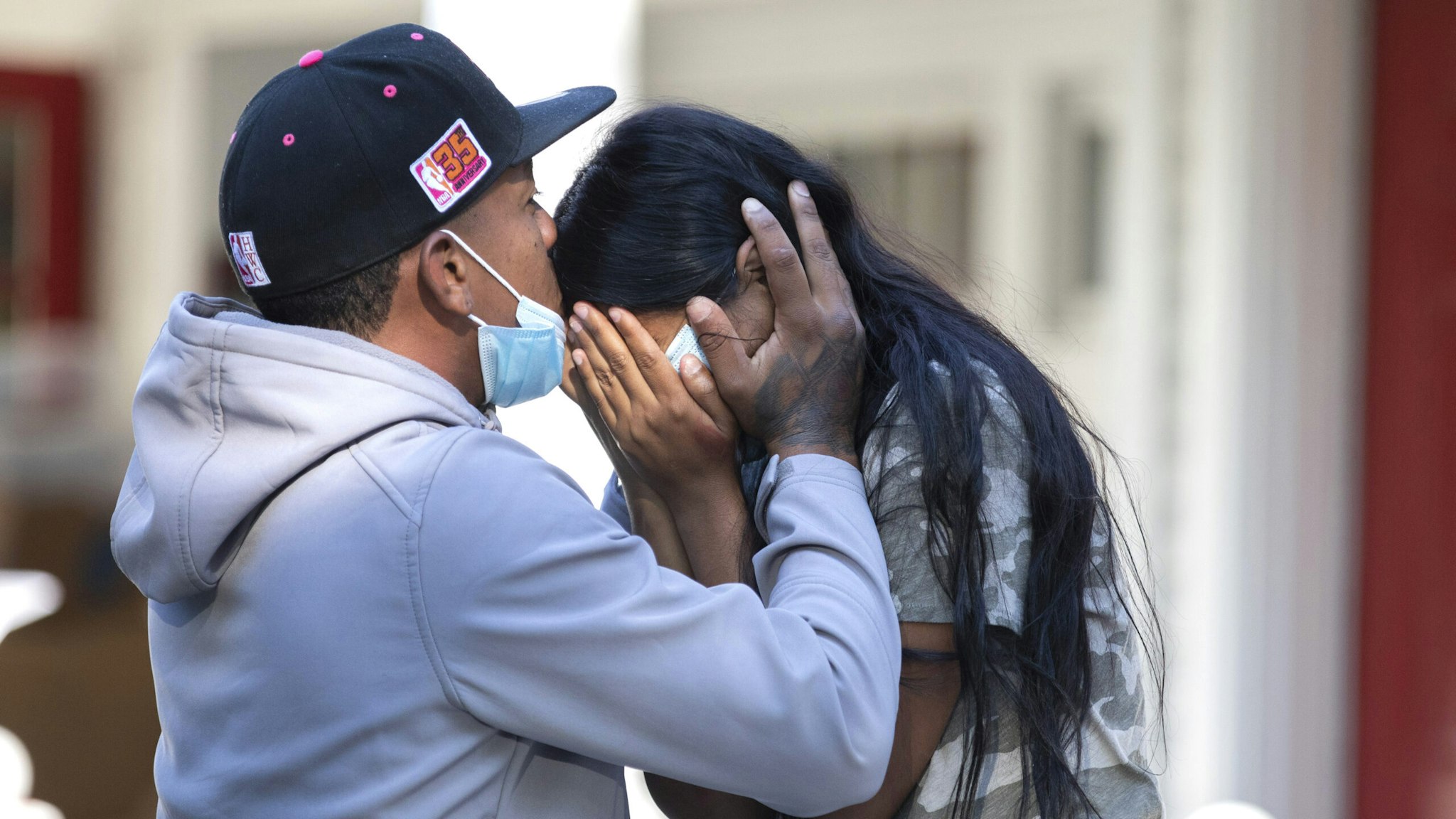 Edgartown MA - September 15th 2022: Rafael Eduardo (left) an undocumented immigrant from Venezuela hugs another immigrant outside of the Saint Andrews Episcopal Church, on Marthas Vineyard.