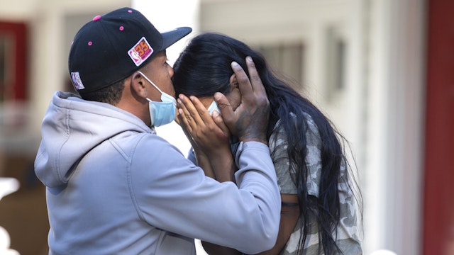 Edgartown MA - September 15th 2022: Rafael Eduardo (left) an undocumented immigrant from Venezuela hugs another immigrant outside of the Saint Andrews Episcopal Church, on Marthas Vineyard.