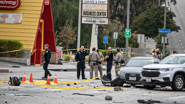 LOS ANGELES, CA - AUGUST 04: Officials investigate a fiery crash where multiple people were killed near a Windsor Hills gas station at the intersection of West Slauson and South La Brea avenues on Thursday, Aug. 4, 2022 in Los Angeles, CA.